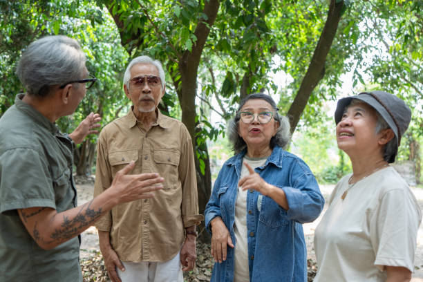istock Asian senior talking at garden 2116597186
