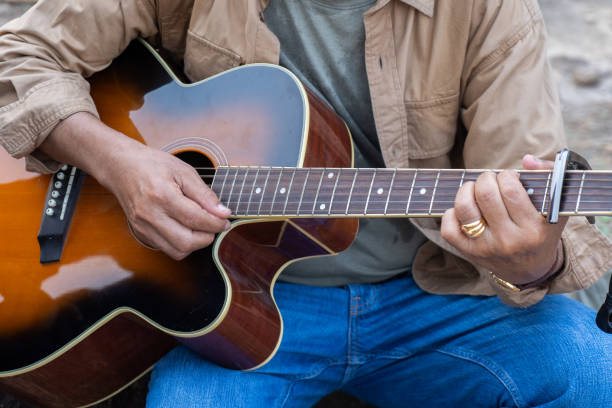 istock Asian senior enjoy playing guitar on the hill 2116601351
