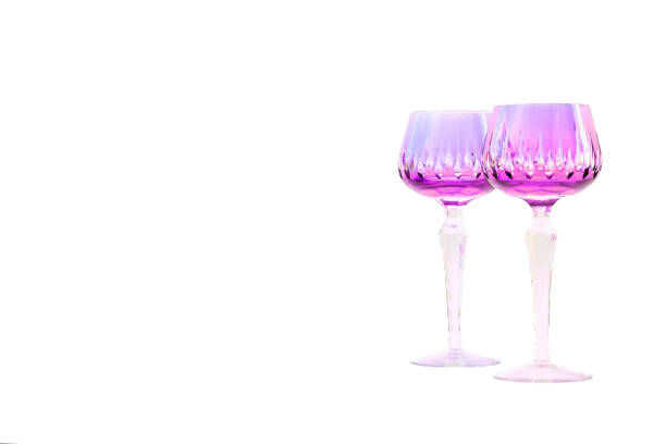 istock Two pink lilac purple  wine crystal glasses on white, ceremony 2116672053