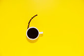 up of coffee and coffee bean on yellow background, with copy space for text