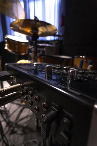 Close-up of a professional music mixer in the studio, selective focus. Vertical photo