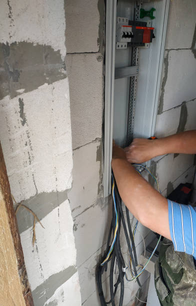 istock A professional electrician joins an electric wire to a power shield. 2116694036