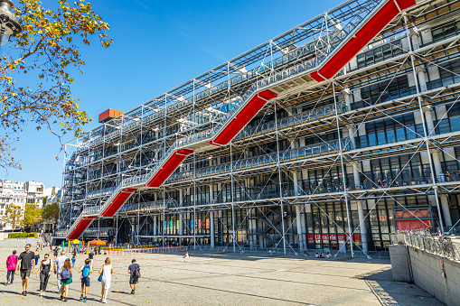 Paris, France - September 10, 2023 : Exterior view of the Pompidou Center built in 1977 by architects: Renzo Piano, Richard Rogers and Gianfranco Franchini in Paris, France with tourists walking on the square