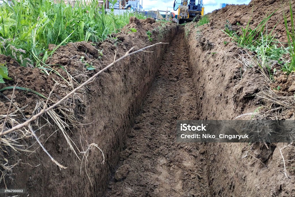 Shallow Digging Construction Excavator Digging A Shallow Groove For Electrical Wiring ...