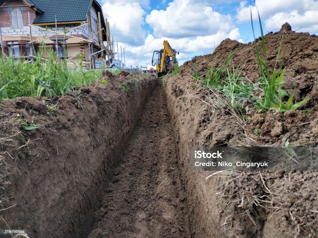 Shallow Digging Construction Excavator Digging A Shallow Groove For Electrical Wiring ...