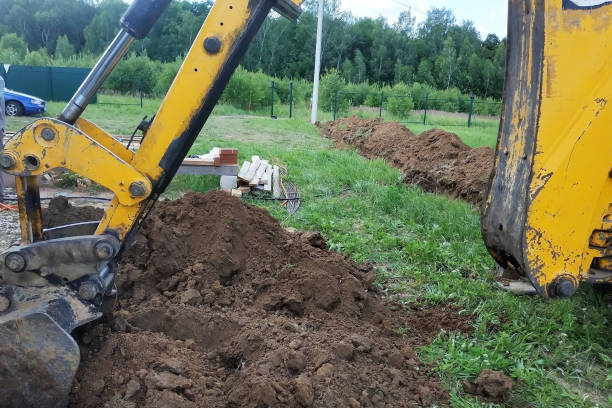 istock In a private plot, the excavator digs a trench. 2116703746