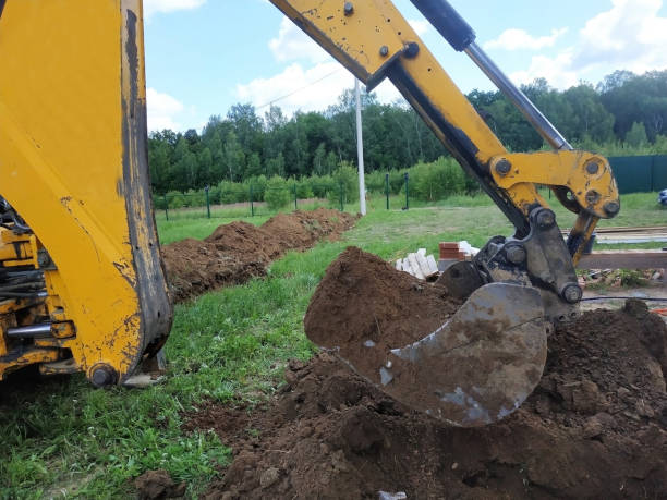 istock In a private plot, the excavator digs a trench. 2116704265
