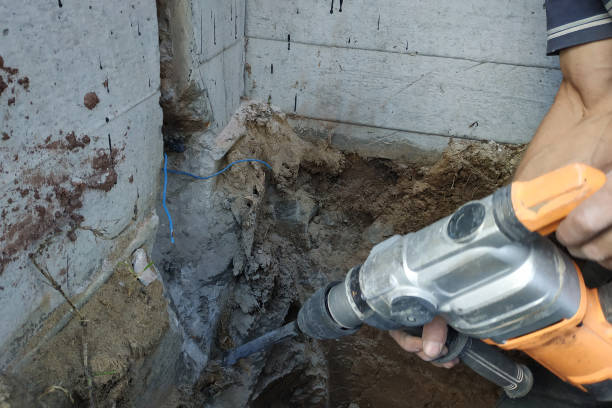istock jackhammer in action, pneumatic construction tool, drilling a hole in the concrete wall. 2116707910