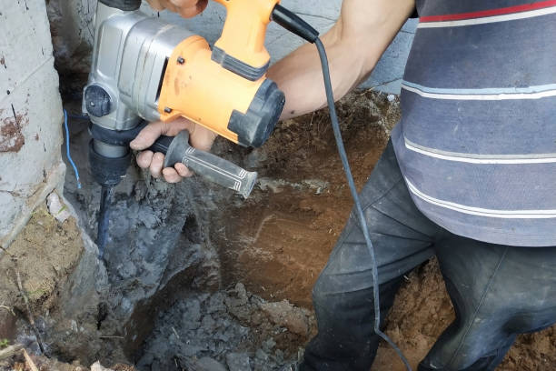 istock Construction industry worker using pneumatic hammer drill to cut the wall concrete brick, close up 2116707918