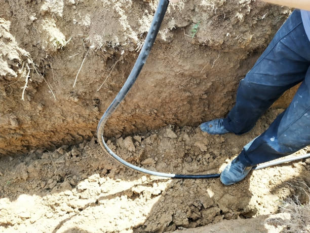 istock The workman will shield the electric cable in the trench. 2116709446