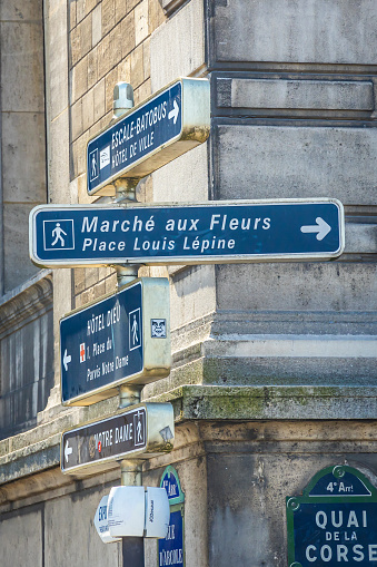 Paris, France - September 10, 2023 : Flower market and Place Louis Lépine direction sign in a street of Paris, France