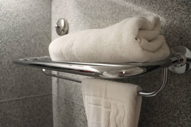Image of modern bathroom/ toilet elegance/ white towel on chrome rack.