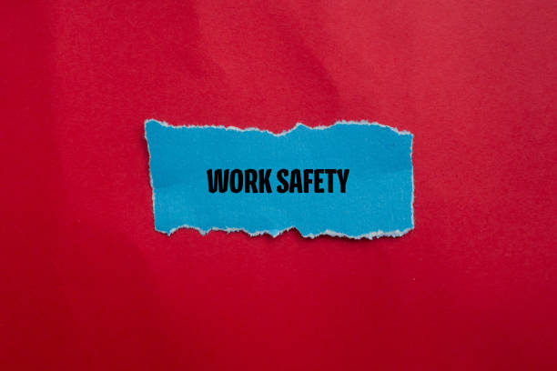 Work safety words written on blue torn paper piece with red background. Conceptual symbol. Copy space.