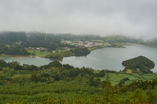 Lagoon of the Seven Cities with fog inside the volcanic crater, where there are two lakes: the green lake and the blue lake on the island of San Miguel in Azores, Portugal