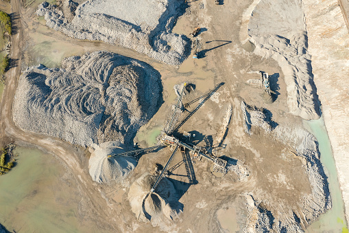 Aerial view of quarry, stone crusher, stone sorting conveyor belts, heavy industry