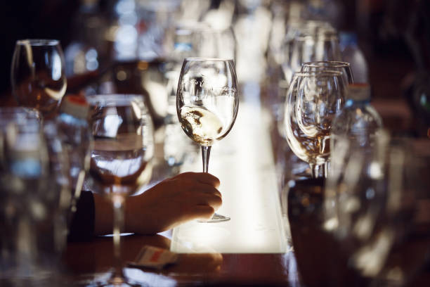 istock Person Holding White Wine Glass Close Up 2116833522