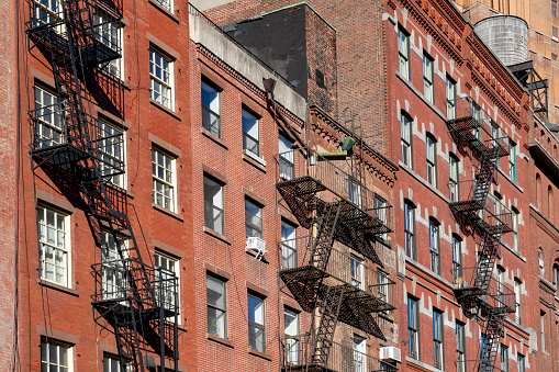 Classic exterior metal fire escapes on or near Greenwich Street in New York City.