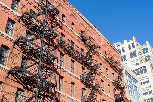 Classic exterior metal fire escapes on or near Greenwich Street in New York City.