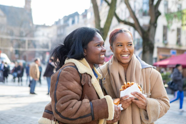istock Two young women eating waffles in Brussels 2116844628
