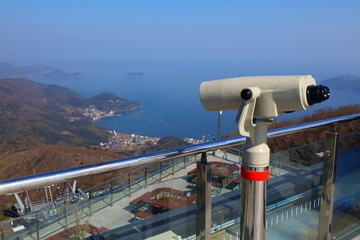 Geoje island in South Korea. Viewpoint lookout with public binoculars on top of cable car mountain in Hakdong.