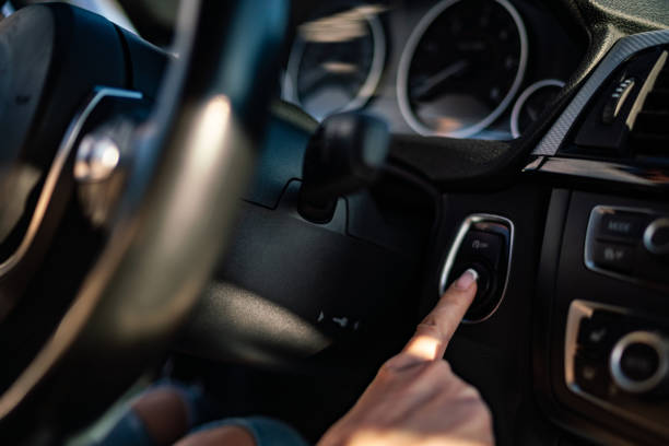 istock Woman pressing the engine start stop button of a car. 2116876939