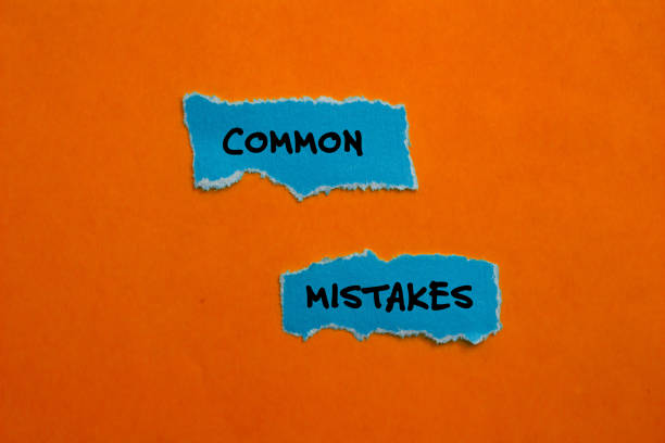 istock Common mistakes words written on blue torn paper pieces with orange background 2116880105