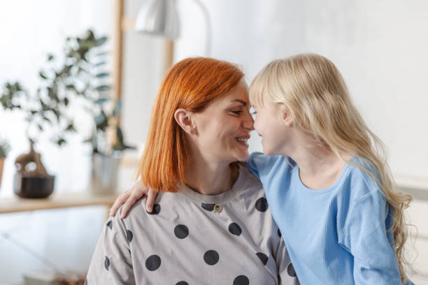istock Cute moments between mother and daughter in bed 2116883772