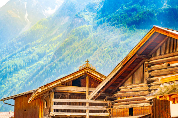Mountain Peak of Osternig or Oisternig and small village on a sunny summer day, Italy-Austria border, Feistritz an der Gail municipality, Carinthia, Carnic Alps, Austria, central Europe.