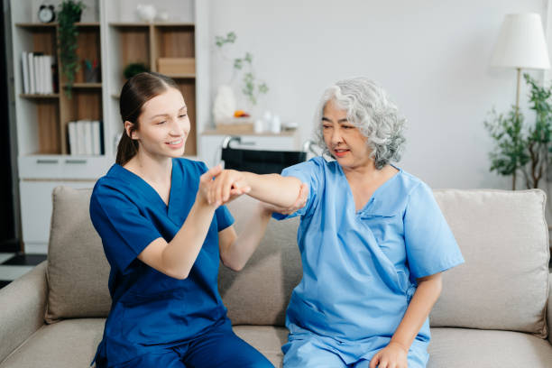 istock Physiotherapist helping elderly woman patient stretching arm during exercise correct in hand during training hand with patient Back problems 2116908724