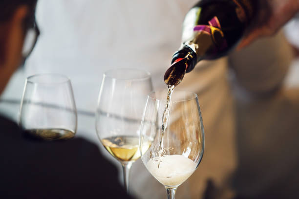 istock Close-up Pouring Sparkling White Wine into Glass for Tasting 2116940026
