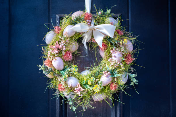 Beautiful Easter wreath decorated with colorful eggs on blue background with copy space. Easter concept design. 3D Rendering, 3D Illustration