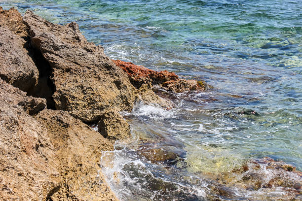 Close-up of the stone shore. Clean sea water on the island of Mallorca.