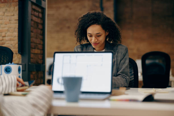 istock Group of female managers sitting in open office while working on digital tablet and laptop 2116977507