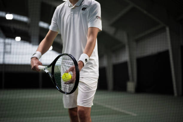 istock Tennis player serving on court 2117004416