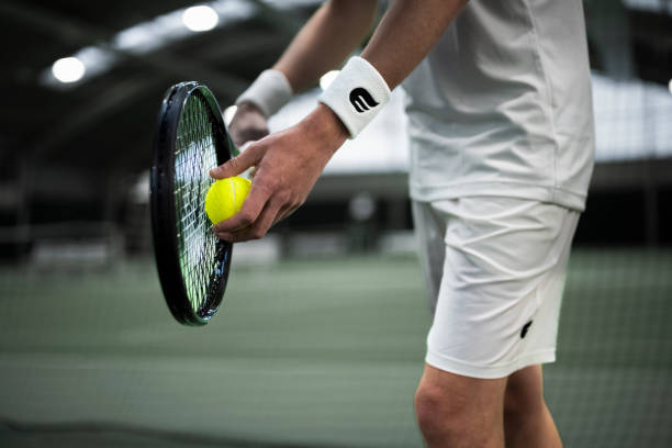 istock Tennis player serving on court 2117006088