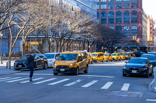 Greenwich village, Manhattan, New York, USA - March, 2024. Yellow taxi rank with queue of taxis in Greenwich Village, Manhattan, New York.