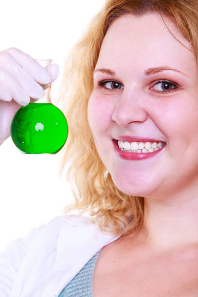 Science and education. Scientist at school laboratory. Happy girl holding chemical flask with green liquid. Student with beaker. Biology experiment, sample formula, chemistry research results.