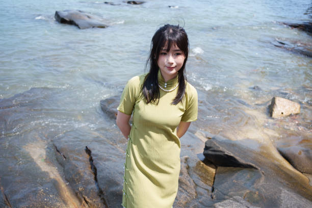 istock girl standing on the beach 2117048557