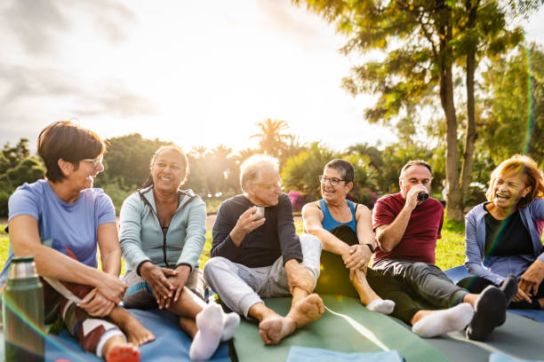 istock Happy multiracial senior friends drinking a tea after workout activities in a park 2117055823