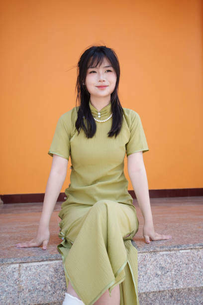 istock young woman sitting on the floor 2117057667