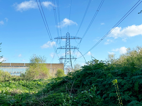 Pylon and building on waste ground in east London