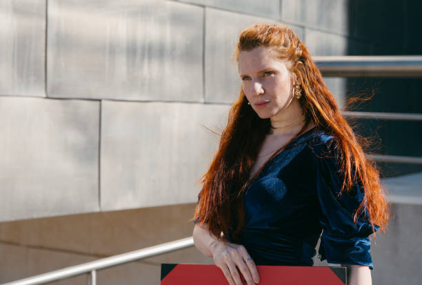 istock Confident woman posing at modern architectural setting, copy space 2117075066