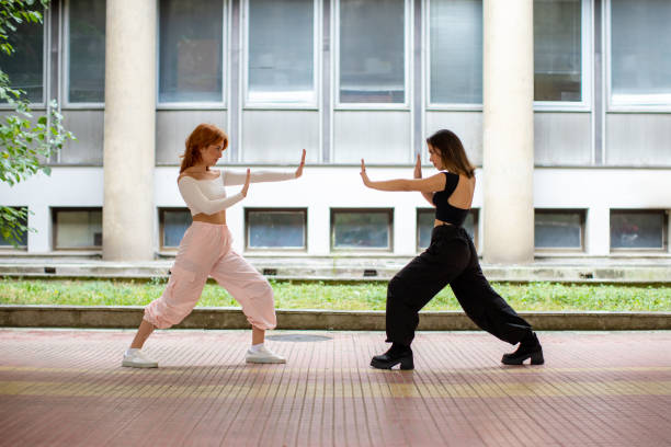 istock two young women in martial arts pose 2117081323