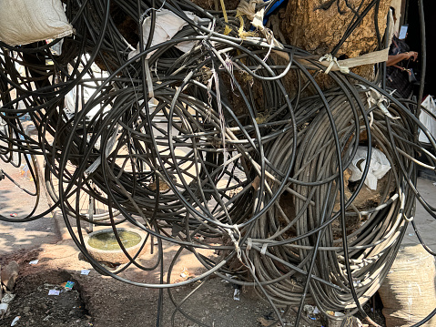 Stock photo showing close-up view of hazardous tangle of electricity cables in an Indian street. Unsurprisingly power outages are common in India.