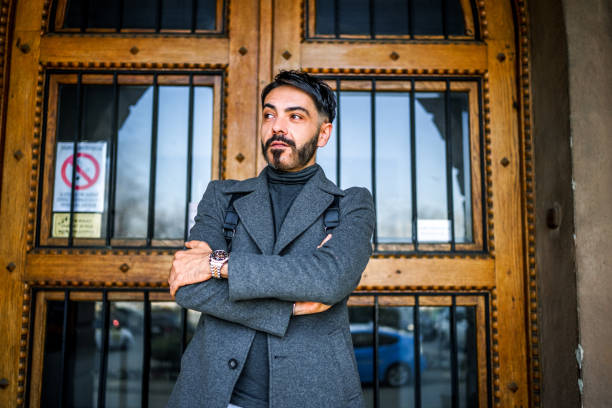 Handsome middle-aged man standing in front of a door