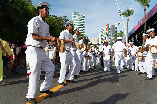 Salvador, Bahia, Brazil - February 03, 2024: Members of the cultural group Fragata Brasileira are seen parading during Fuzue, pre-carnival in the city of Salvador, Bahia.