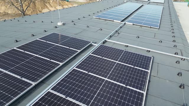Photovoltaic installation on a production hall roof. Source of ecological energy for the industry.