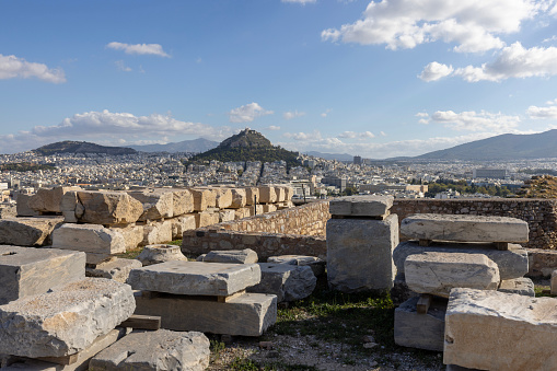 Athens, Greece - October 17, 2022:  Picturesque view from Acropolis hill on Mount Lycabettus and the city skyline on a sunny day