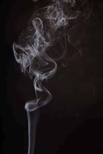 Captivating swirls of delicate white smoke against a dark backdrop, evoking mystery and elegance. A mesmerizing representation of transformation and the fleeting nature of time. Perfect for health and wellness, environmental, and creative industries.