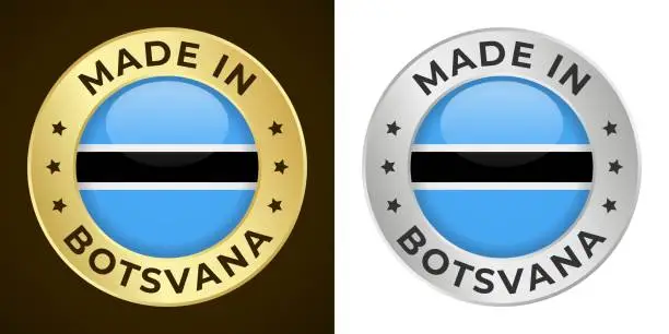 Vector illustration of Made in Botsvana - Vector Graphics. Round Golden and Silver Label Badge Emblem Set with Flag of Botsvana and Text Made in Botsvana. Isolated on White and Dark Backgrounds